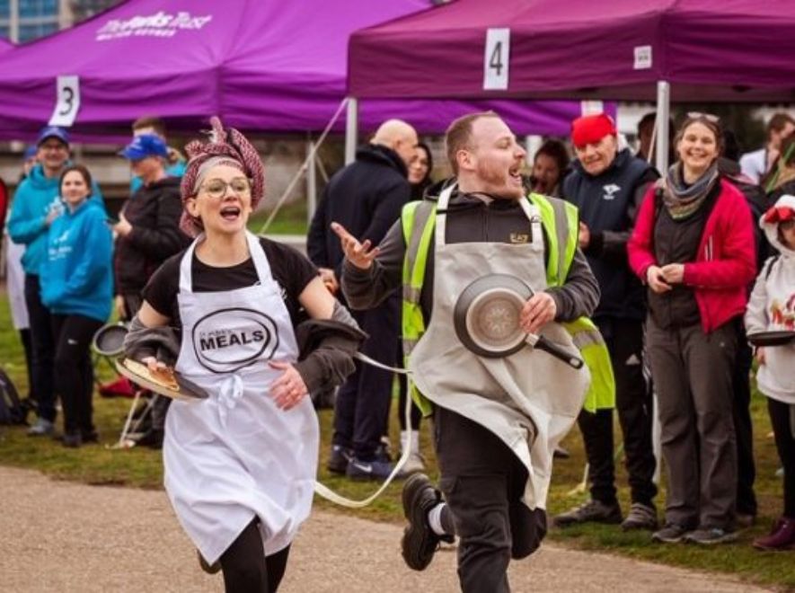 Man and woman in pancake day race